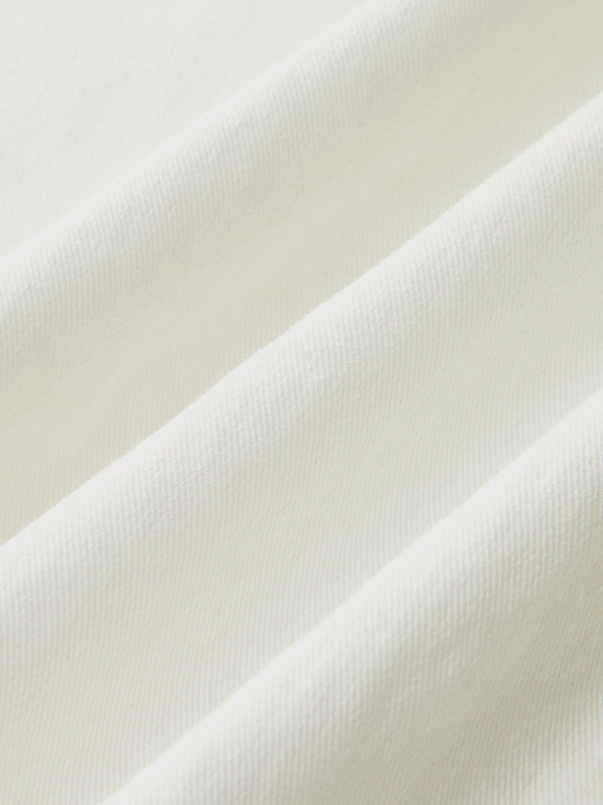 White ribbed cotton-blend cami dress with buttoned front and soft, elegant folds.
