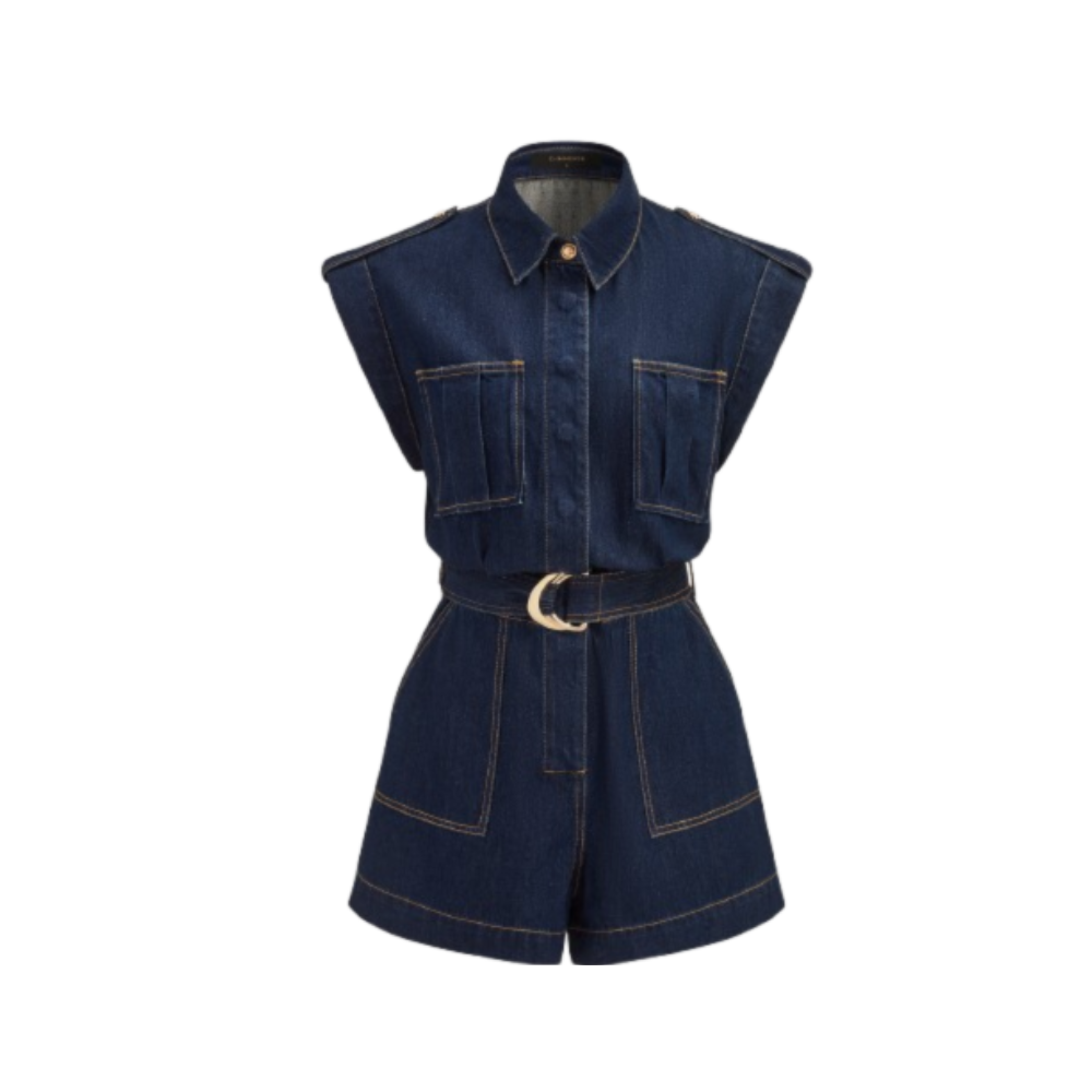 Sleeveless denim romper with wide shoulders, chest pockets, gold-buckle belt, and bold stitching.