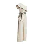 Cream one-shoulder jumpsuit with ruffles, black piping, wide legs, side stripes, and belt.