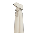 Cream one-shoulder jumpsuit with ruffled neckline, black piping, waist tie, and wide legs.
