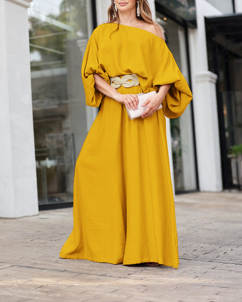 LA FINE FLEUR Skew Neck Lantern Sleeve Blouse and Wide Leg Pants Set in a light fabric.