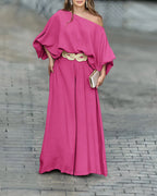 Skew neck lantern sleeve blouse paired with wide leg pants, featuring a woven beige belt.