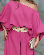 Bright pink skew neck lantern sleeve blouse paired with wide leg pants from LA FINE FLEUR.