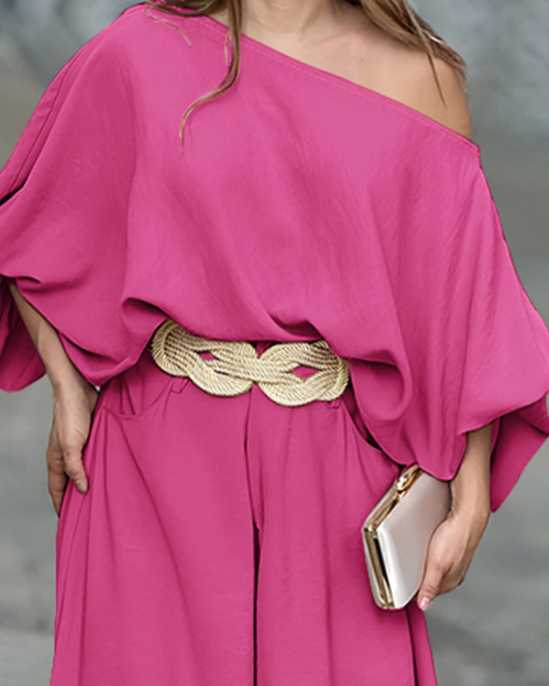 Bright pink skew neck lantern sleeve blouse paired with wide leg pants from LA FINE FLEUR.